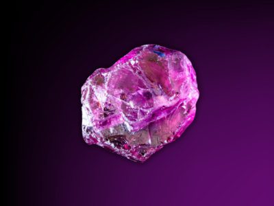a rhodolite garnet with a black and purple background