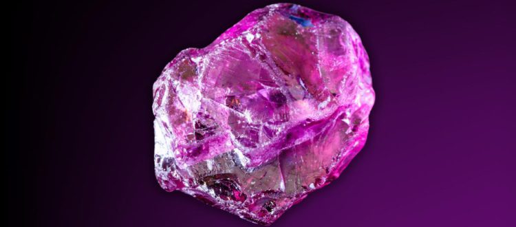 a rhodolite garnet with a black and purple background