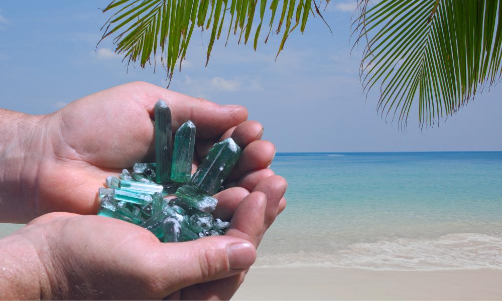 a person holding a handful of green tourmaline