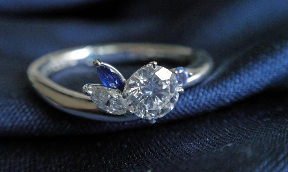 a close up of a white sapphire engagement ring