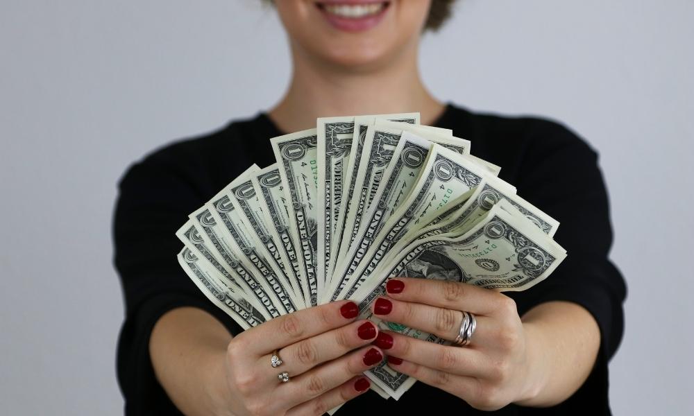 A girl holds money in her hand