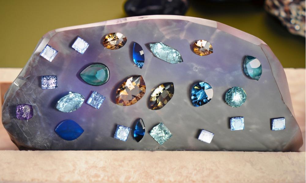 a group of gemstones and omega sapphire stone on a surface