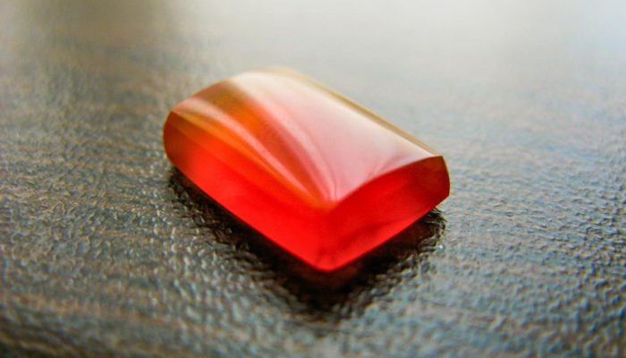 red agate, on a grain-brown surface.