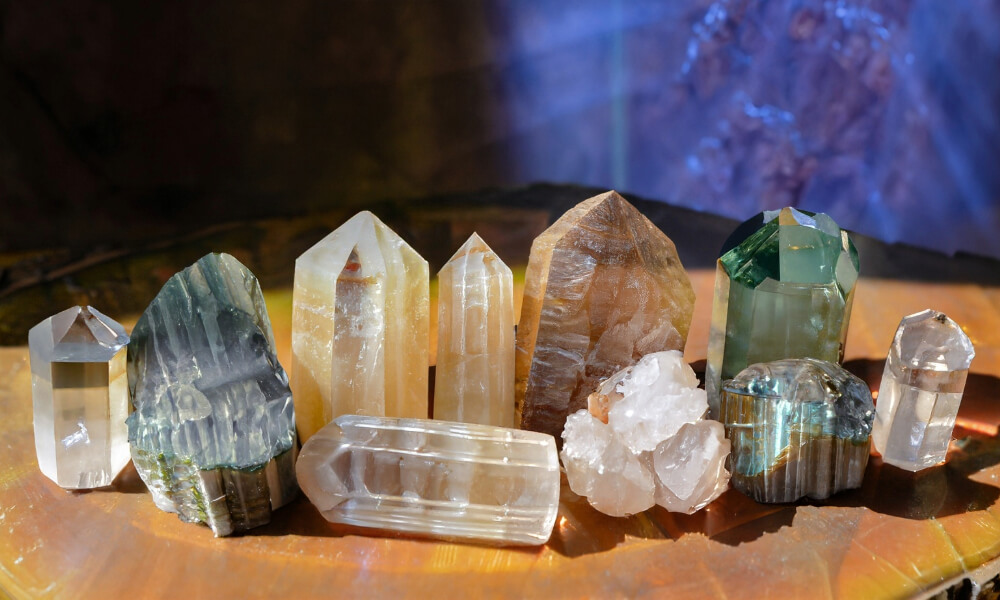 a group of different colored crystals and lemurian crystal