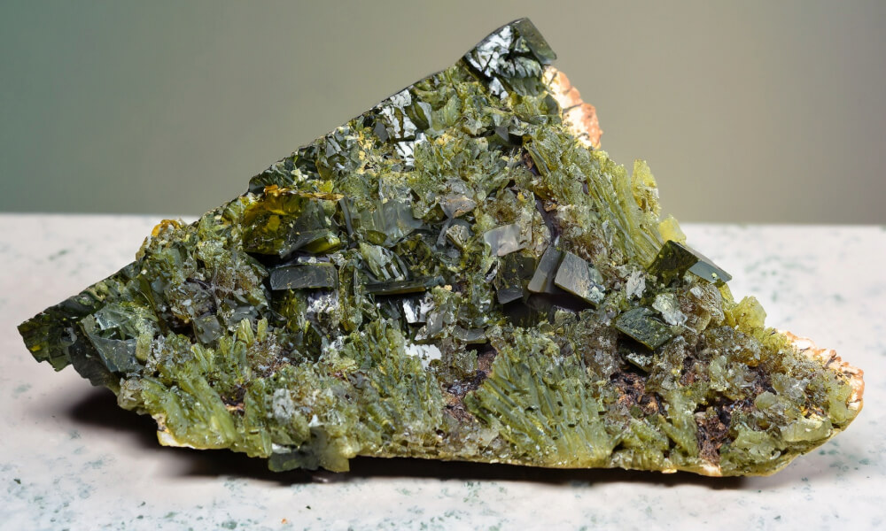 a green rock with epidote crystals