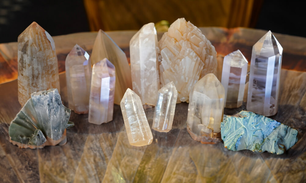 a group of lemurian crystals on a glass table