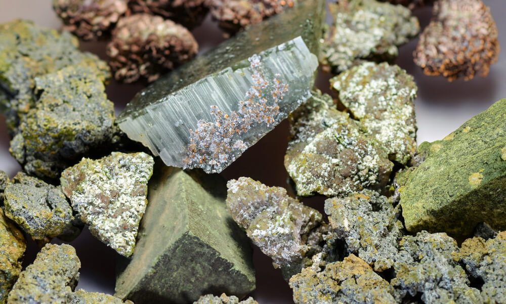 a group of rocks and a piece of epidote crystal
