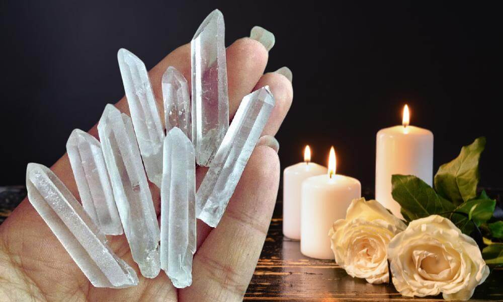 a person holding a bunch of rock crystal clear quartz in their hand