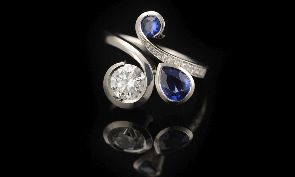 a diamond and vintage sapphire ring on a black background