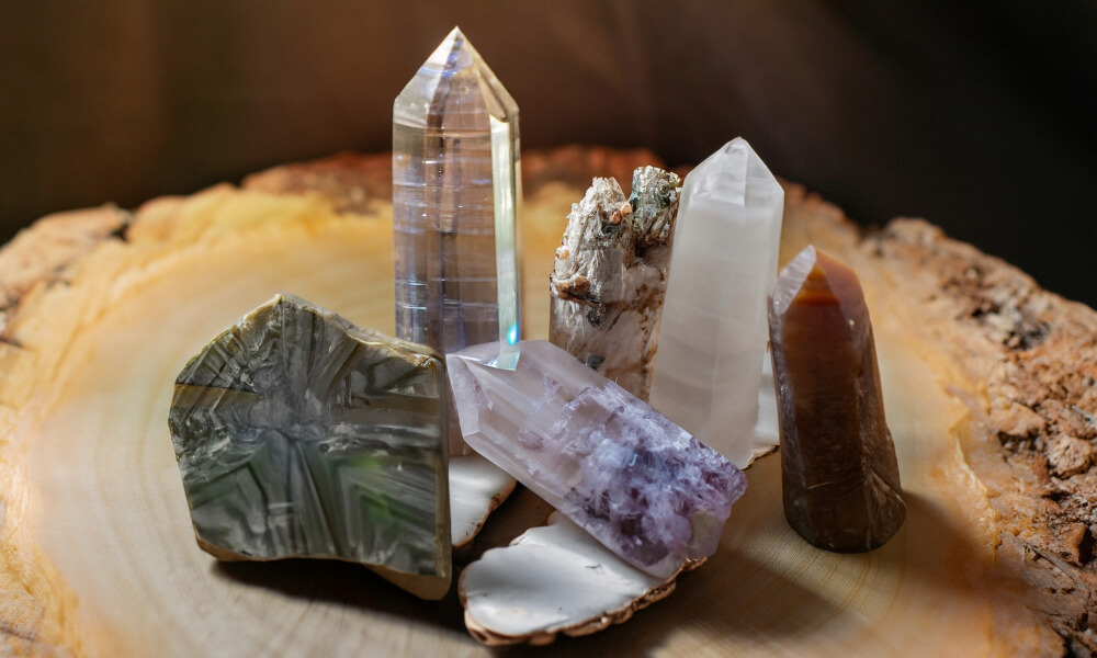 a group of lemurian crystals on a wood surface