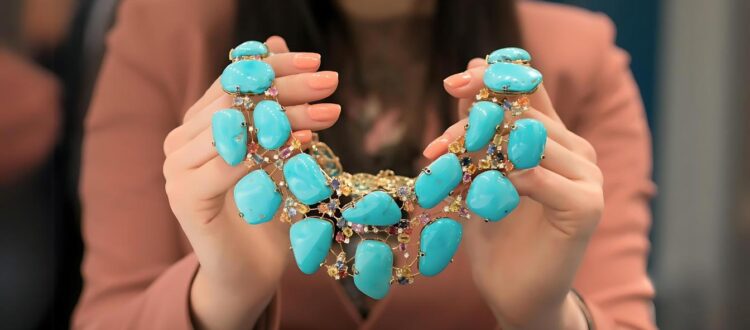 a girl holding a beautiful turquoise necklace