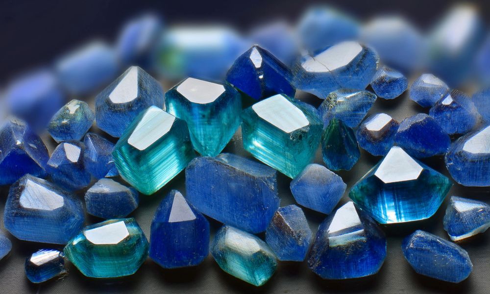 A collection of cut blue emeralds in varying shades of blue.