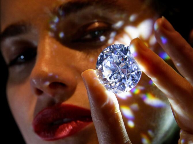 A girl has taken the diamond in her hand. The purpose of showing this picture is why are diamonds so expensive.