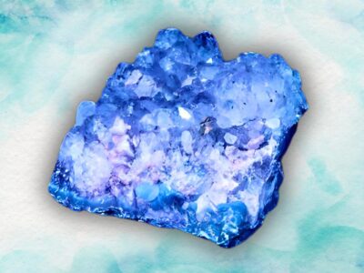 A vibrant blue amethyst and purple crystal cluster on a watercolor background.